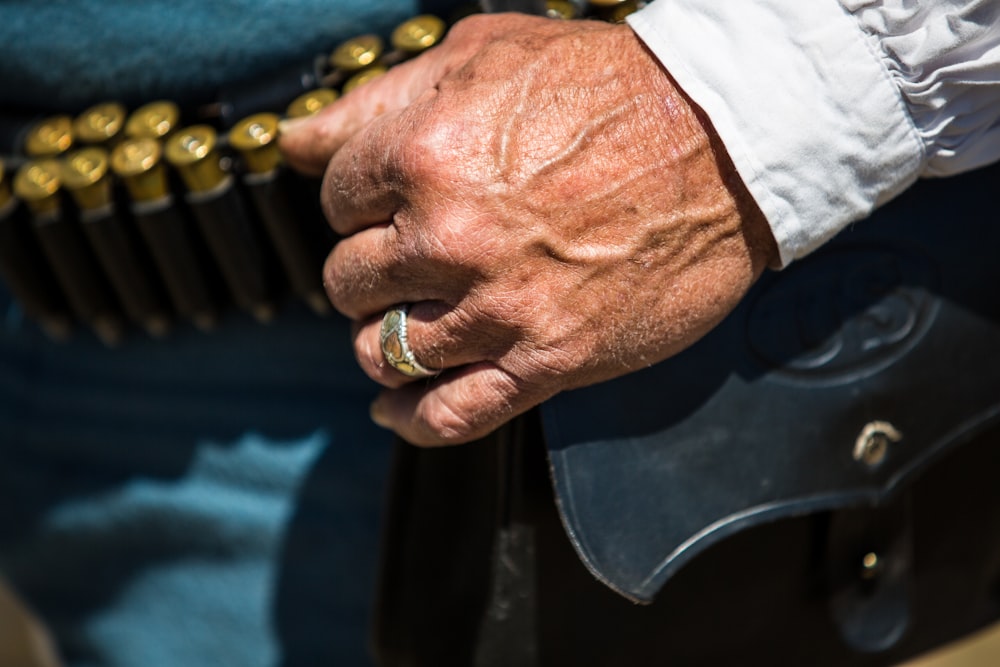 man in white dress shirt wearing gold ring