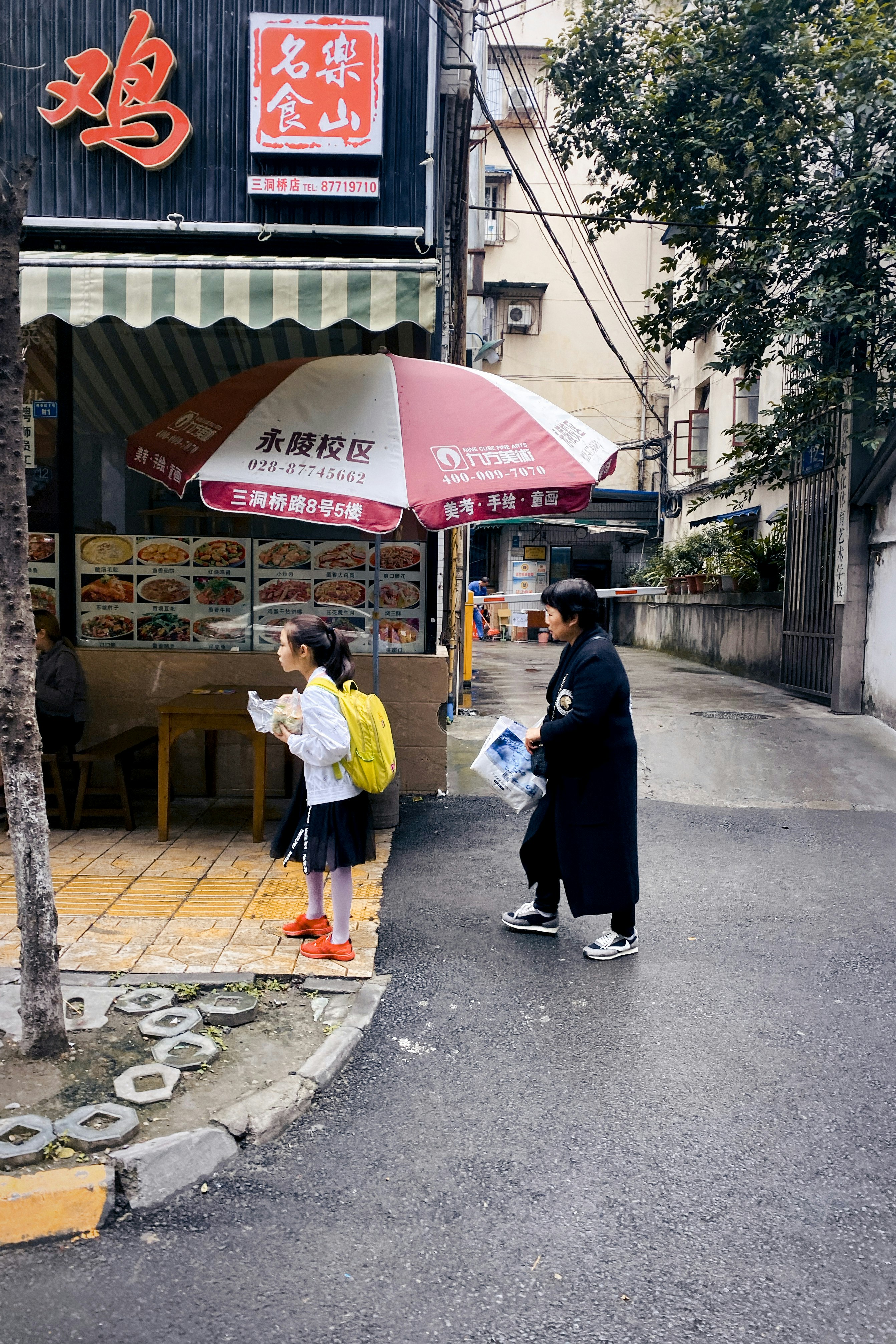 man and woman standing near store during daytime