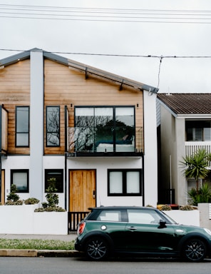 A modern townhouse with a small garden and garage.