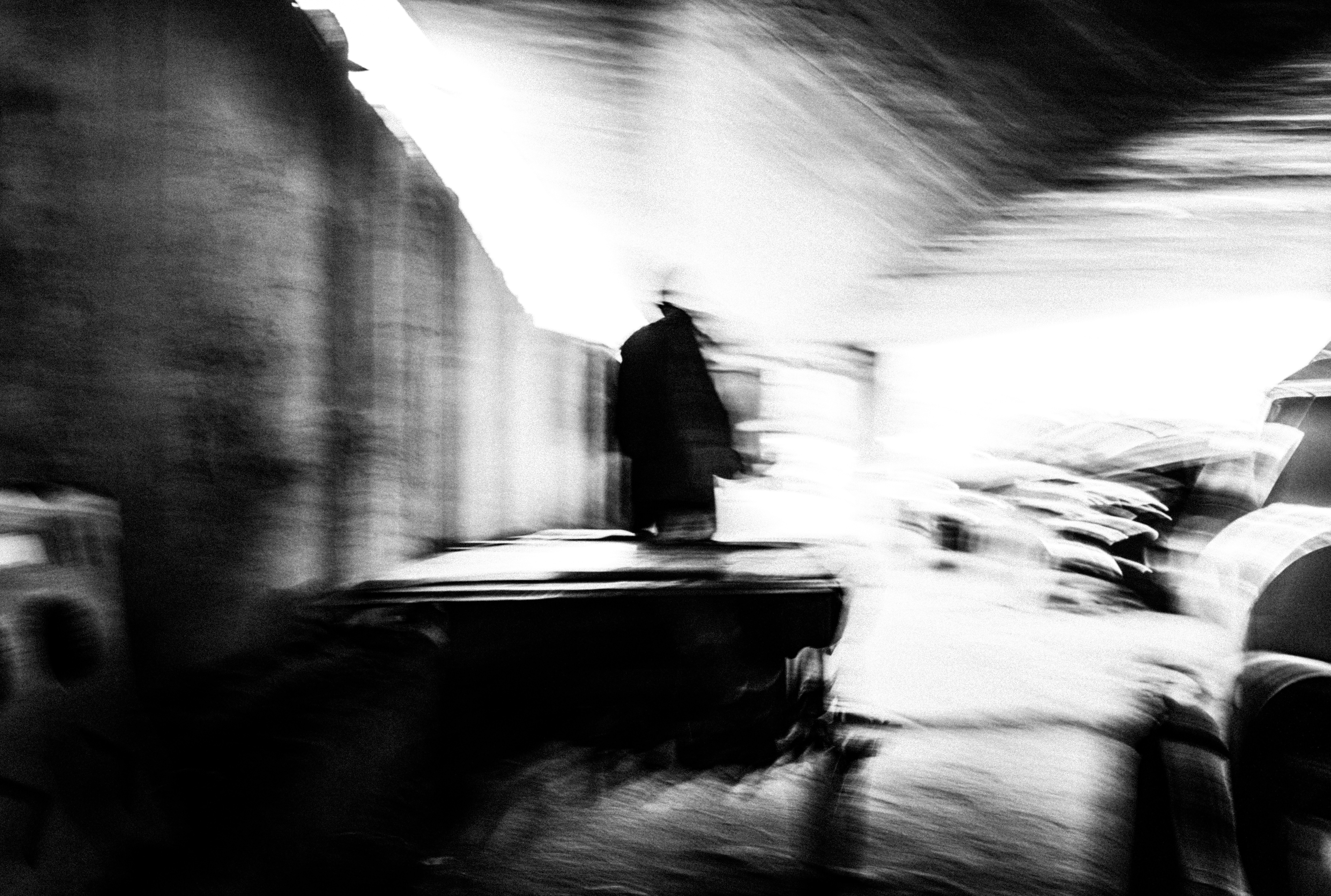 man in black jacket standing on snow covered ground during daytime