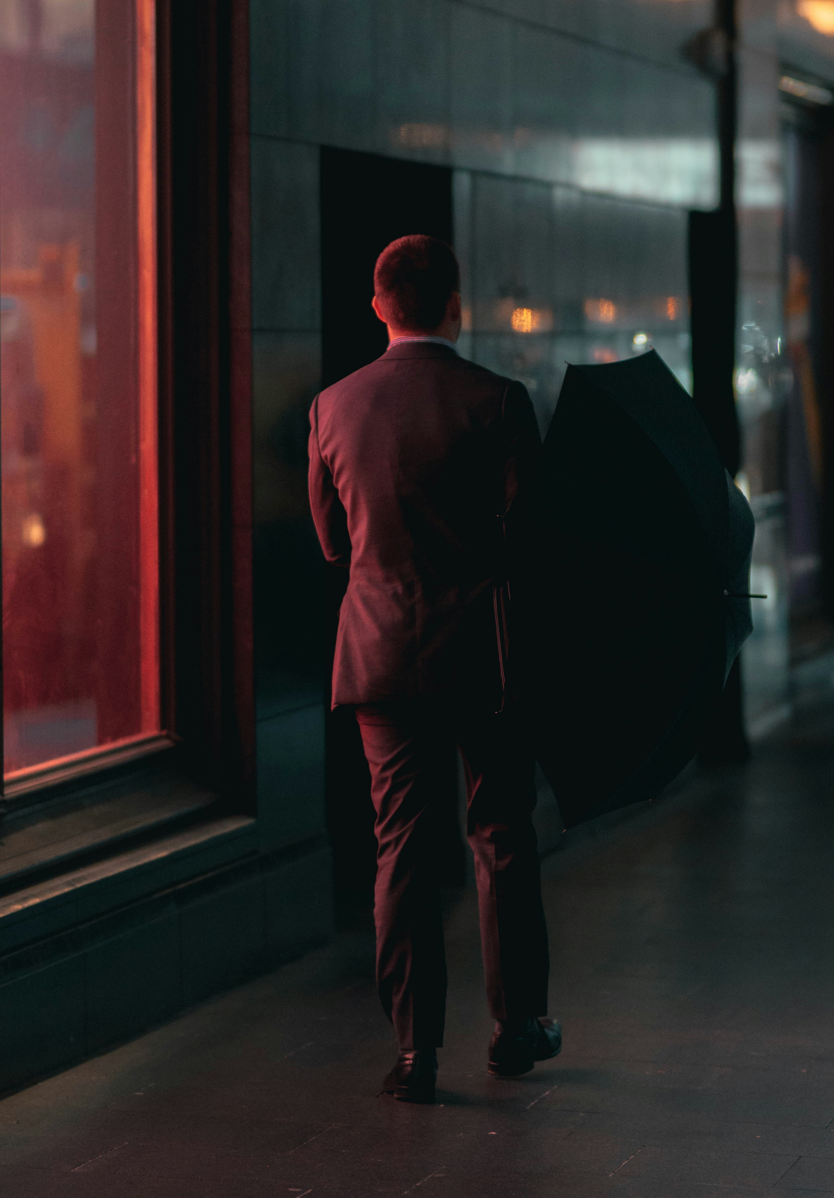 Person walking briskly through a city at dusk