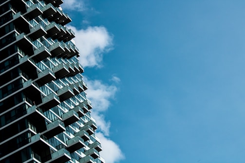 Modern residential building exterior with clear blue sky.