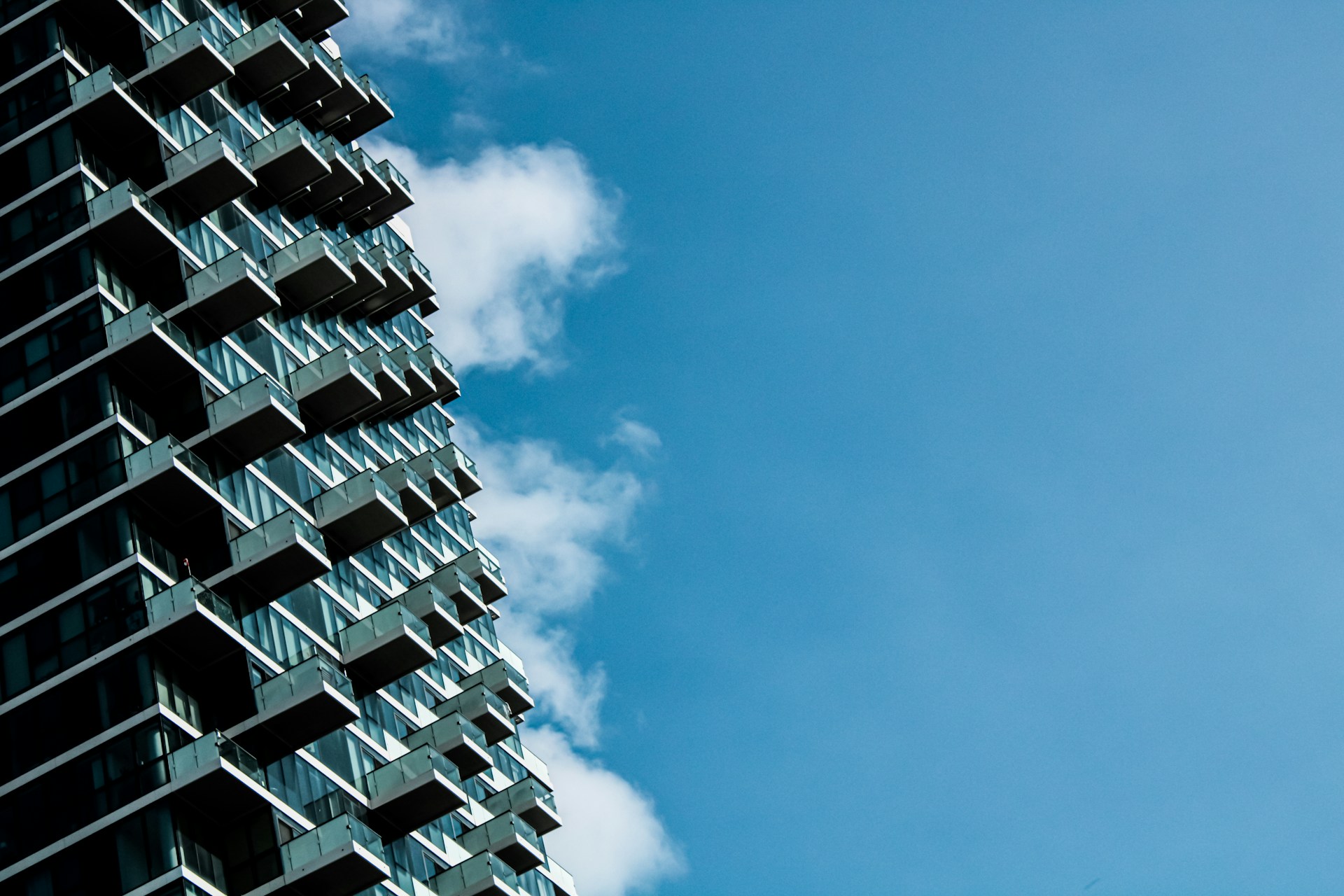 woman wearing yellow long-sleeved dress under white clouds and blue sky during daytime