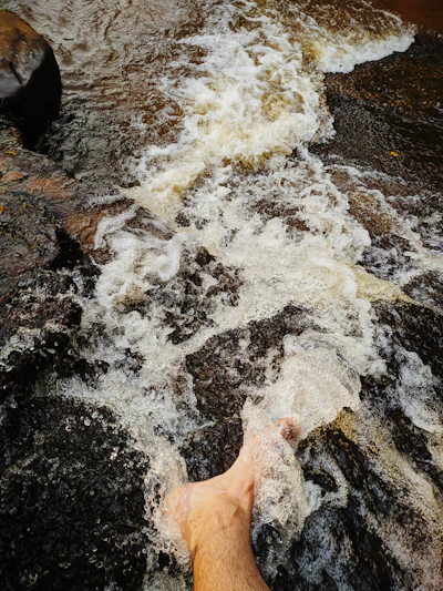 Close-up of a gentle whirlpool swirling around a patient's foot in a medical hydrotherapy spa.