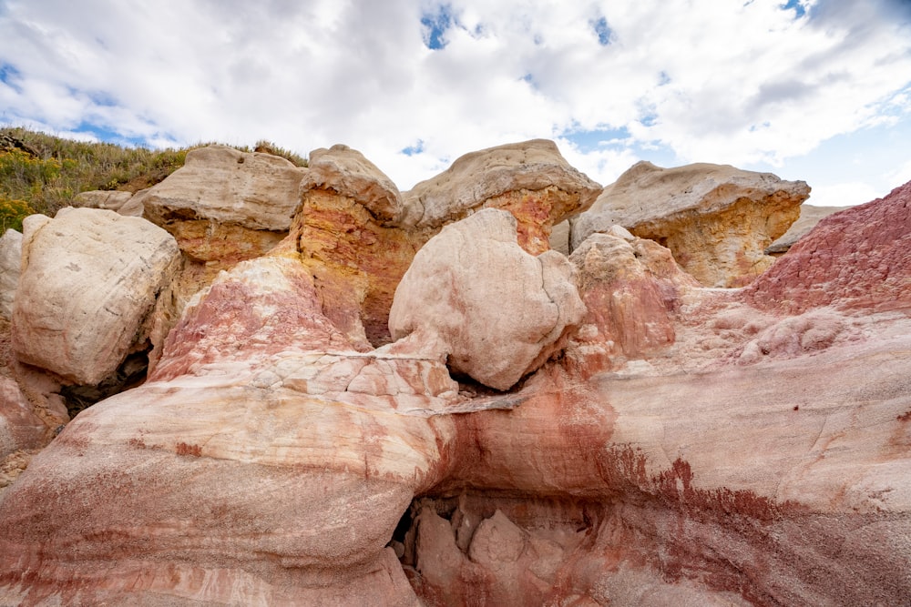 brown rock formation under white clouds and blue sky during daytime