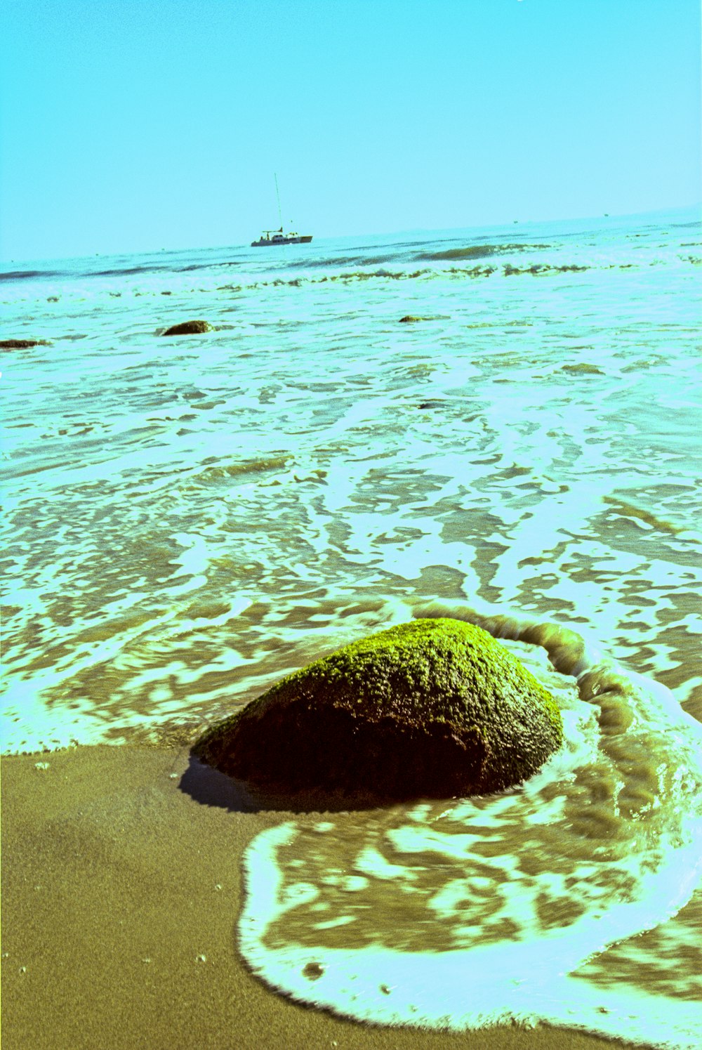 brown rock on blue sea water during daytime