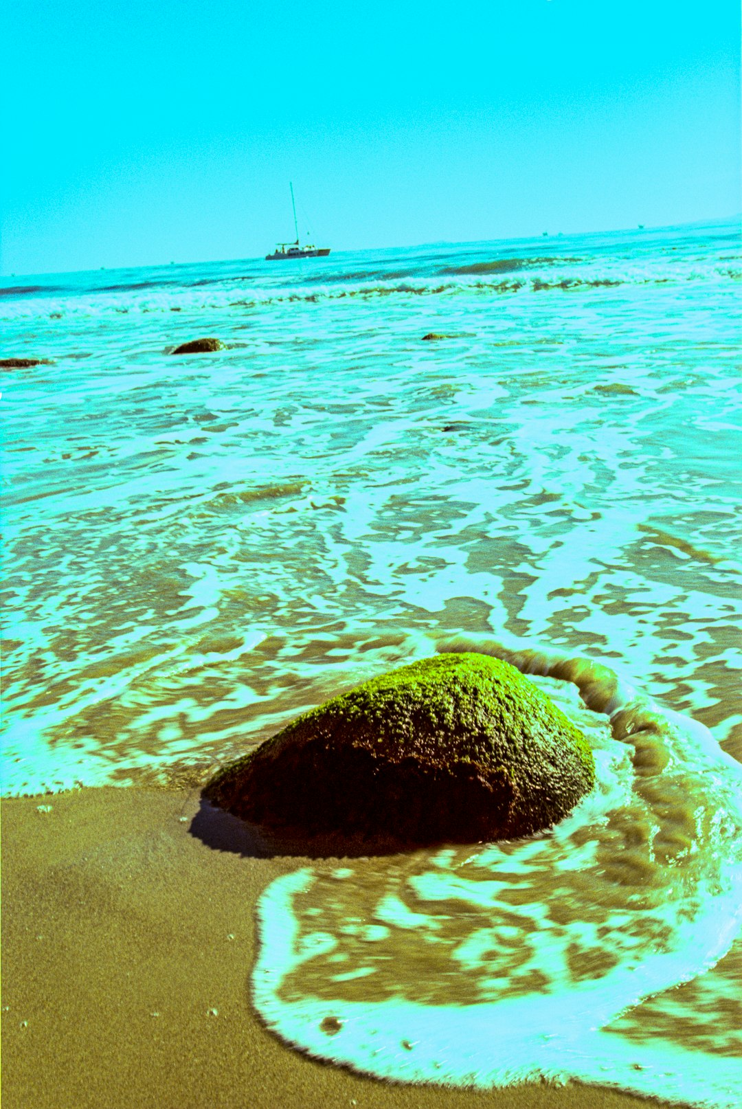 brown rock on blue sea water during daytime