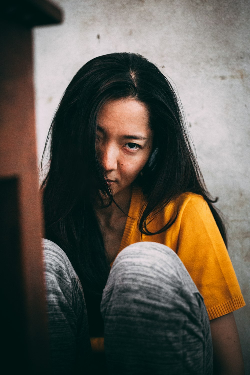 woman in yellow shirt and gray cardigan