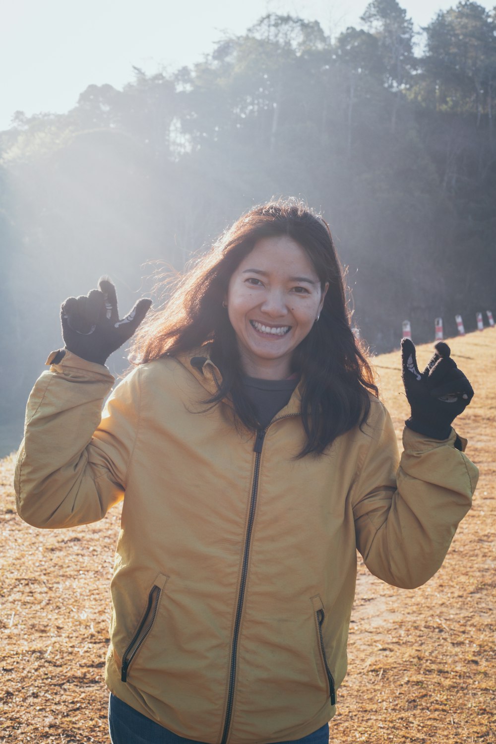 woman in beige zip up jacket smiling