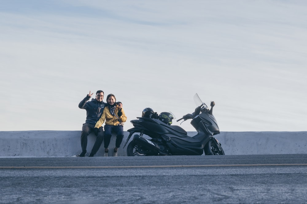 3 hommes et femme assis sur un vélo de sport noir