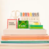 white ceramic mug beside books