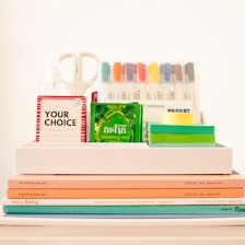 white ceramic mug beside books