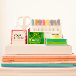 white ceramic mug beside books