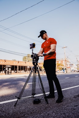 A friendly technician setting up a security camera outside a local business.