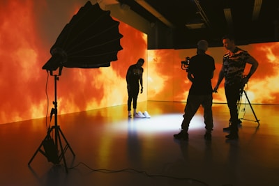 silhouette of people holding umbrella