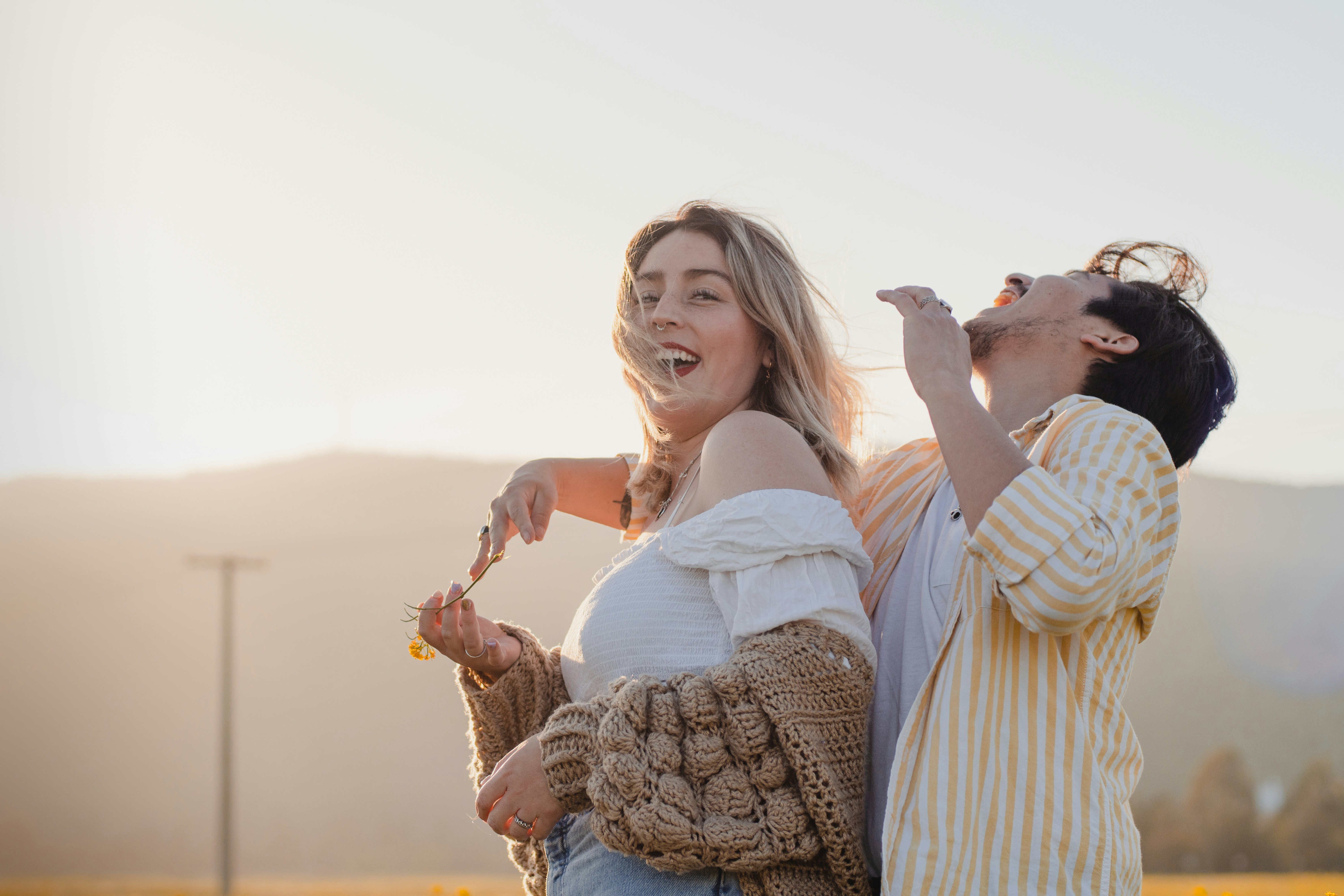 woman in white long sleeve shirt holding brown rope