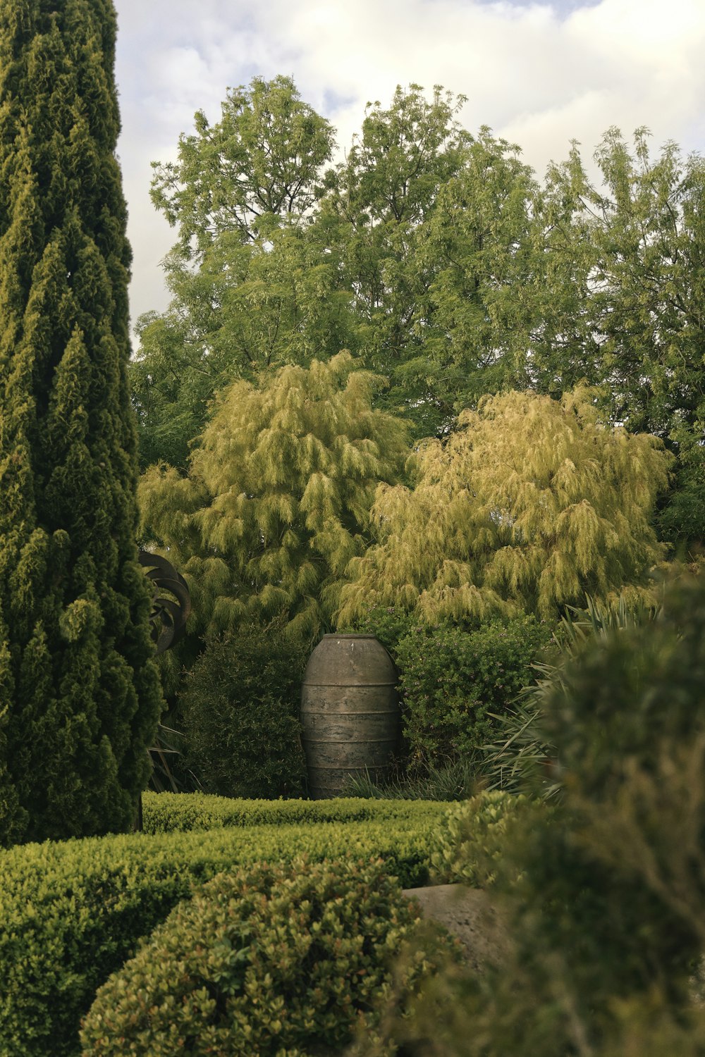 brown wooden barrels on green grass field