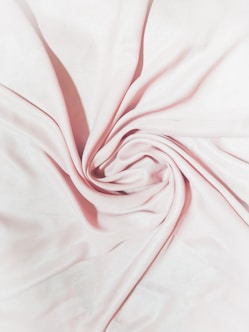 pink textile on brown wooden table