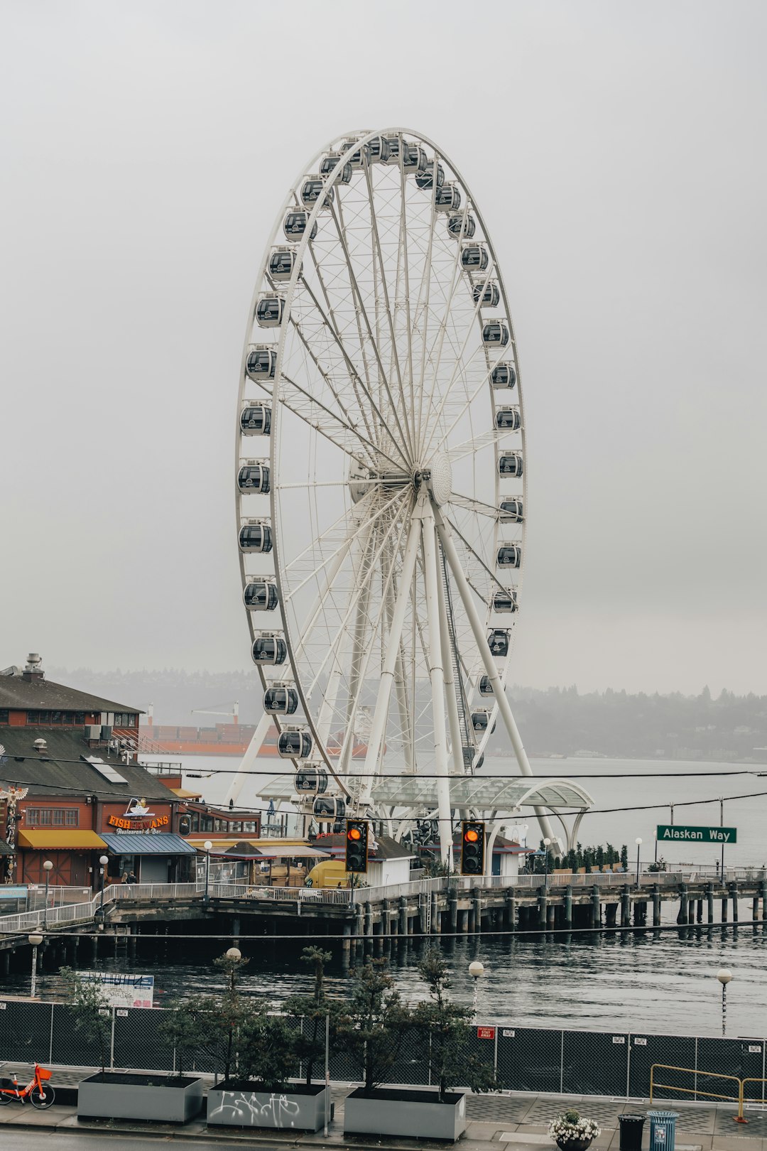 ferris wheel near body of water during daytime