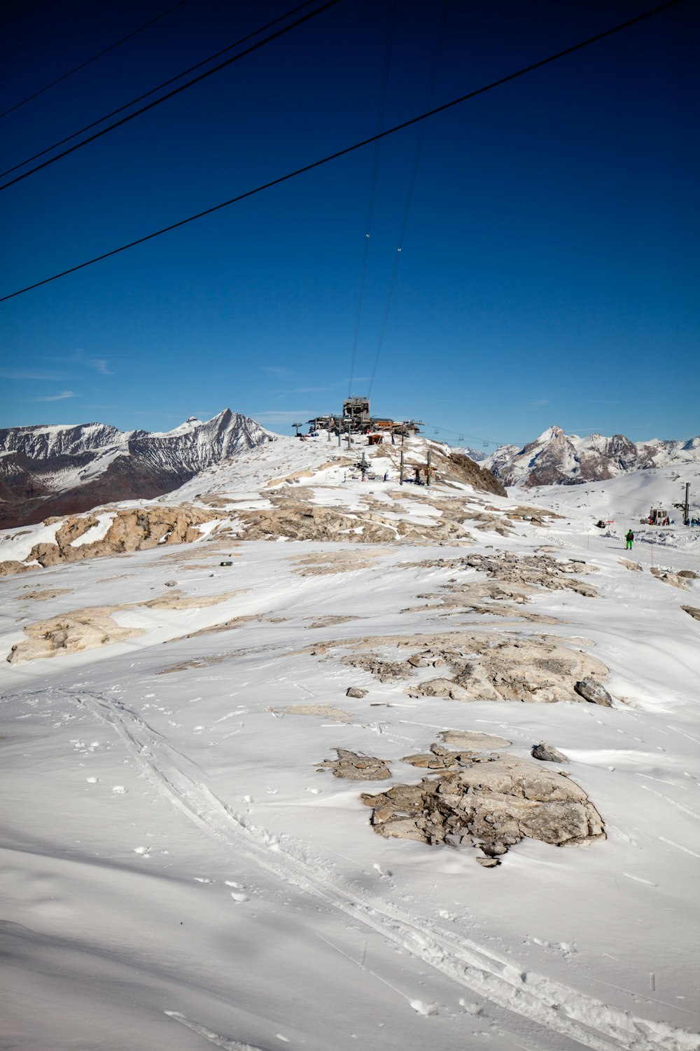 cable cars over snow covered mountain during daytime