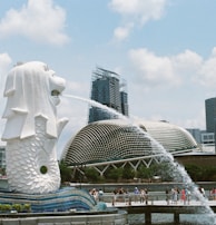 white concrete statue near city buildings during daytime