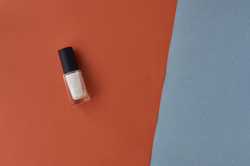 black and silver bottle on orange table