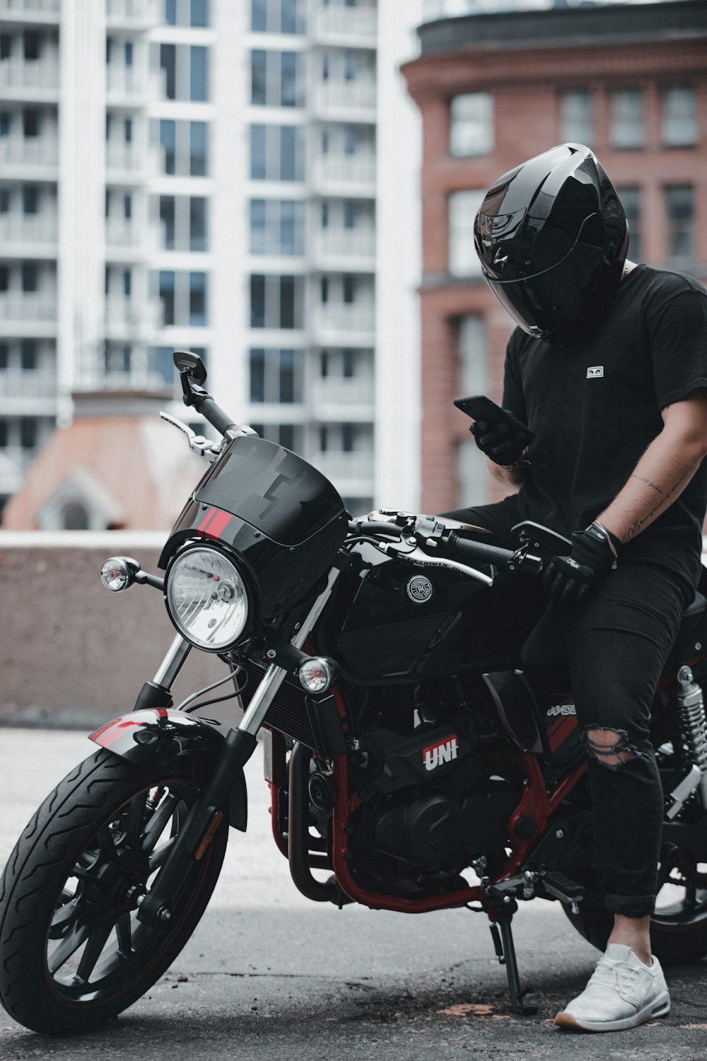 man in black helmet riding black motorcycle