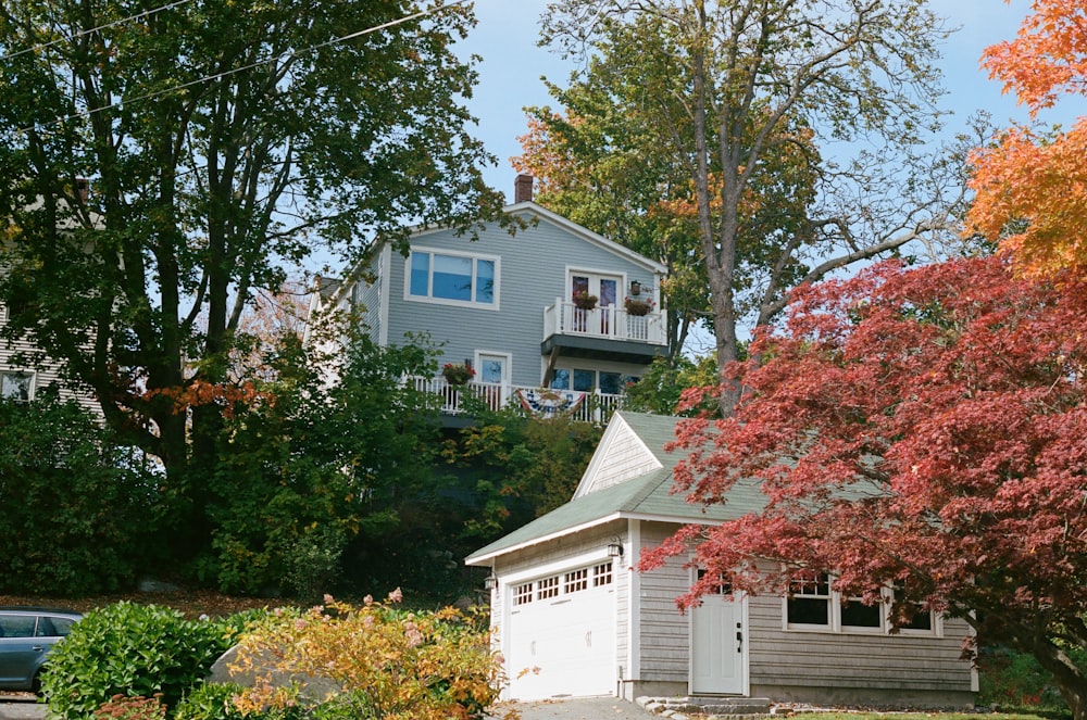 white wooden house near green trees during daytime