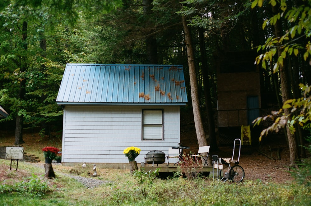 black and white wooden house near green tree during daytime