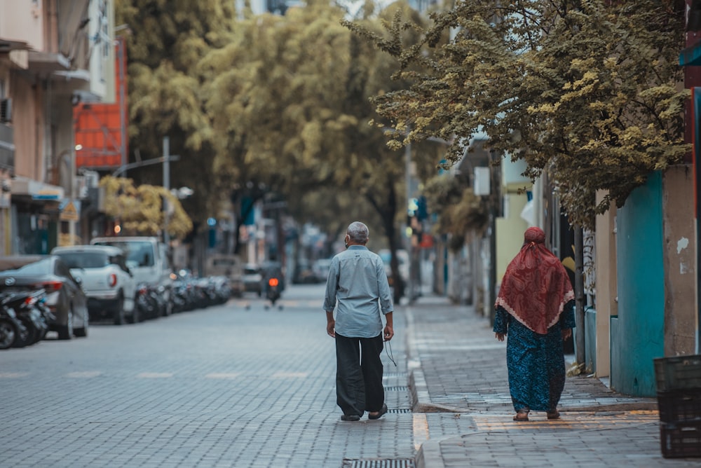 woman in gray coat walking on street during daytime