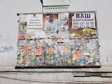 A bulletin board filled with printed job vacancy notices in an urban Pakistani setting.