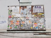 A community bulletin board filled with wanted posters and handwritten safety tips.
