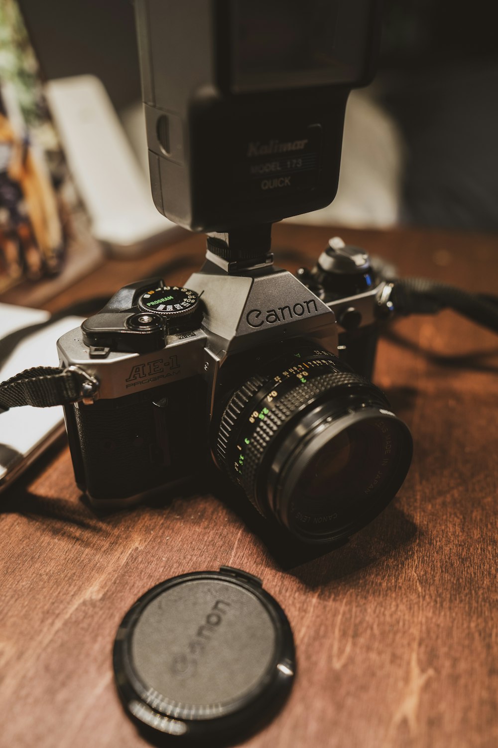 black and silver nikon dslr camera on brown wooden table