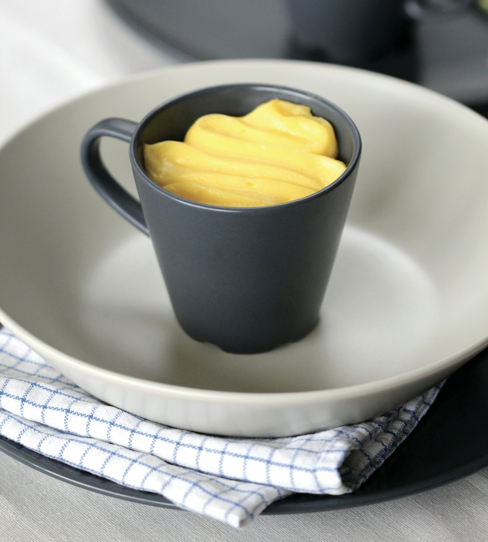 yellow ceramic mug on white ceramic plate