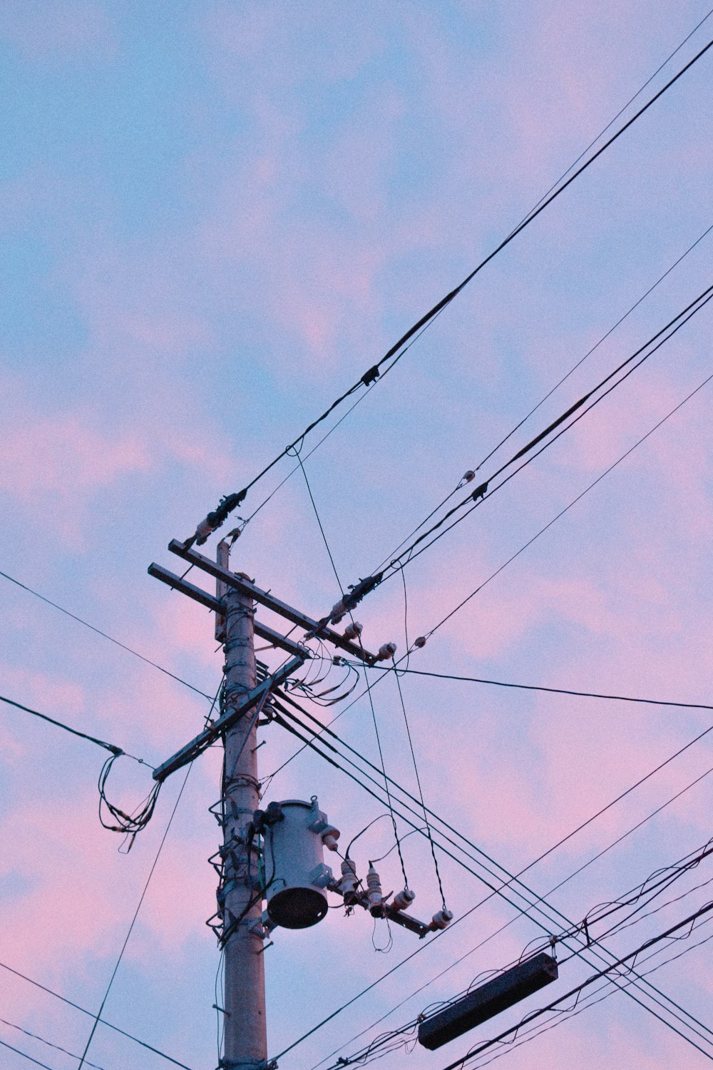 black electric post under blue sky