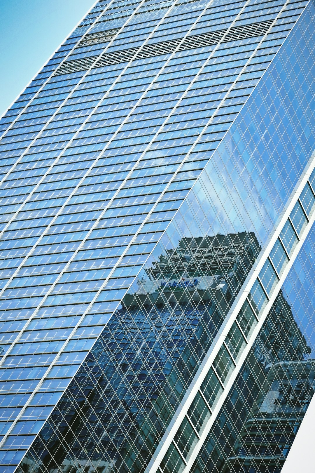 white metal fence near glass building