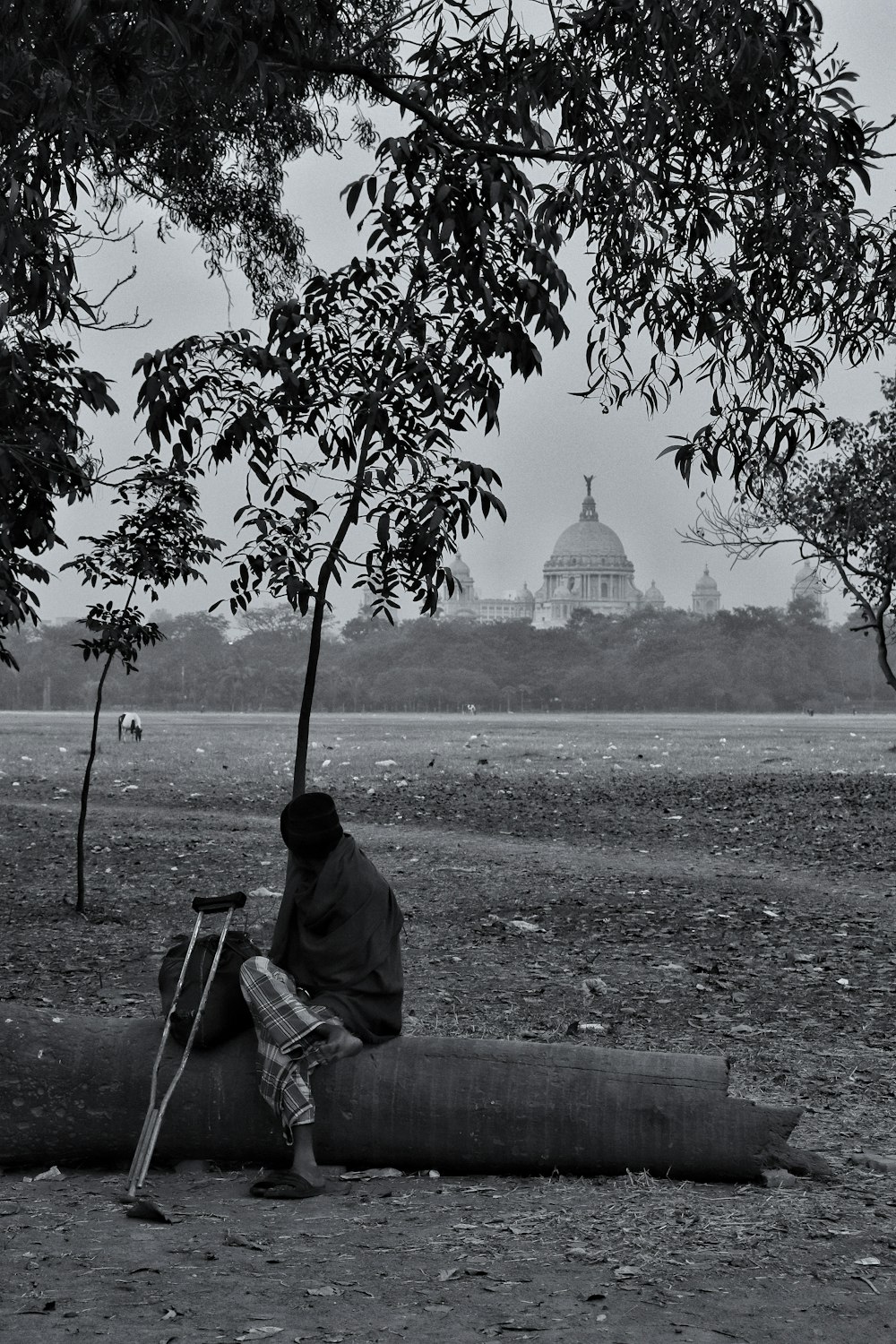 man in black jacket sitting on bench