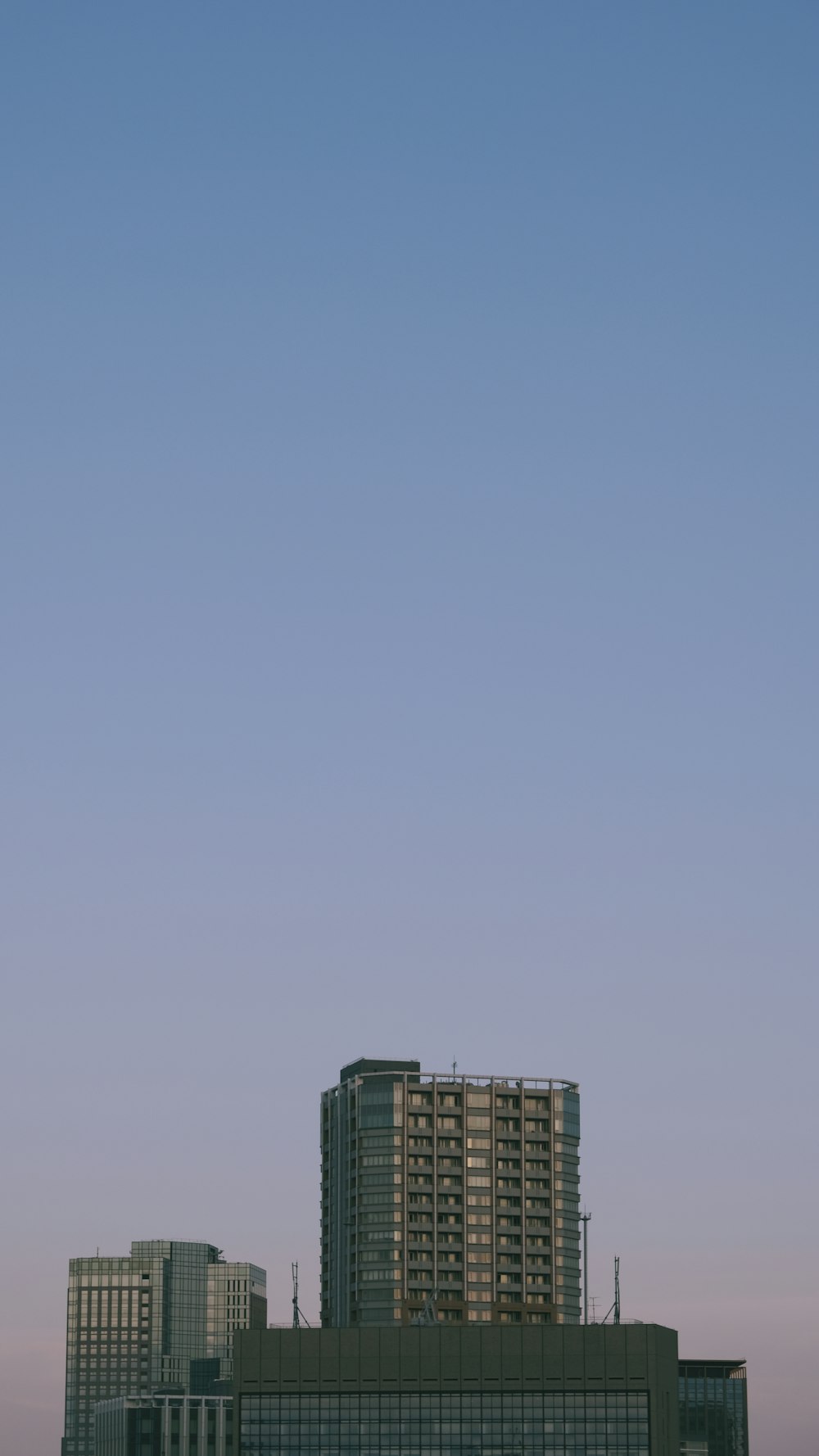 blue and white concrete building under blue sky during daytime