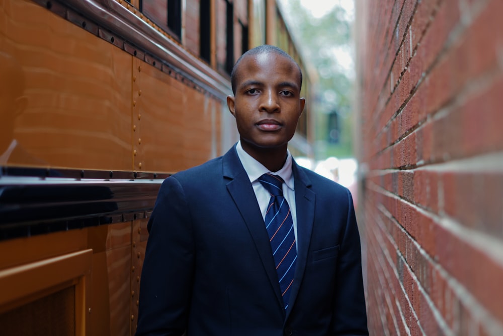 boy in black suit jacket and blue necktie