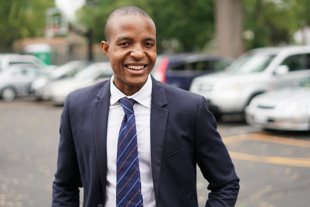 man in black suit smiling