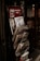 A wire rack filled with various magazines and newspapers is positioned next to a door with a visible sign that reads 'International Press' on the top. The rack contains publications such as 'Architectural Digest,' 'Cornucopia,' and 'Living with Style,' among others.
