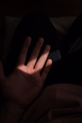 Palm lines highlighted with gentle illumination on a person's hand.