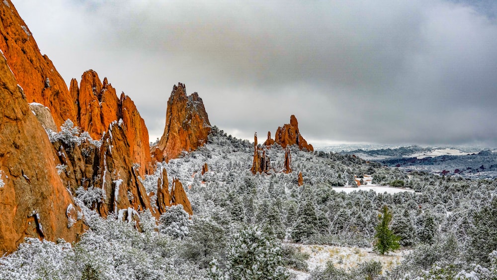 brown rock formation covered with snow during daytime