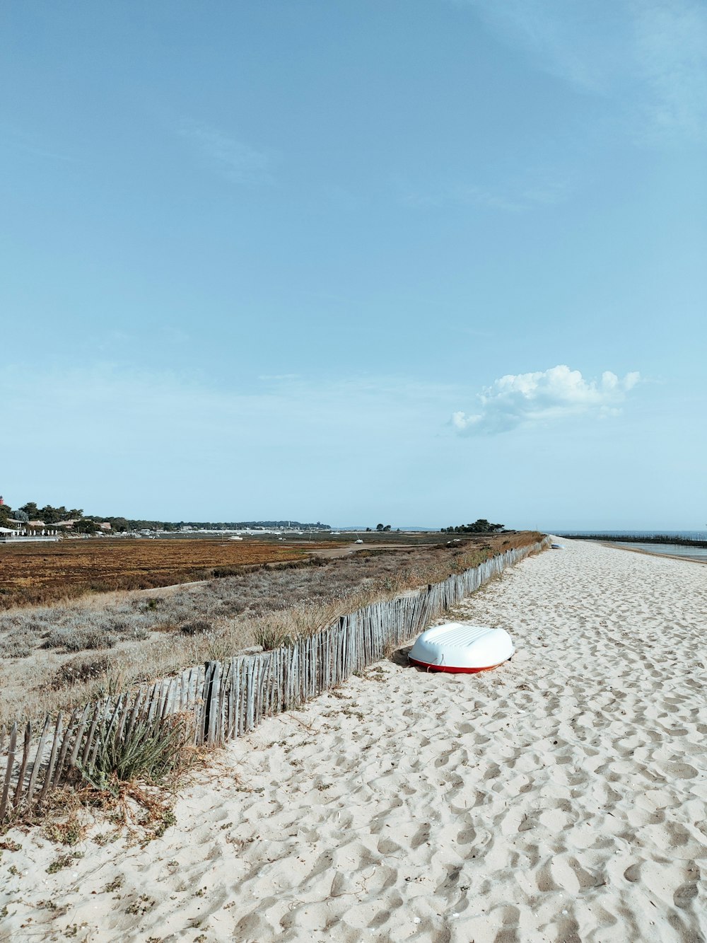 brown wooden fence on beach shore during daytime