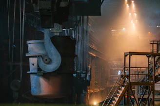 Industrial overhead crane in a factory setting with automated controls and safety features visible.