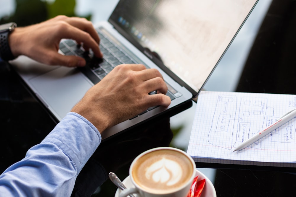 person in blue long sleeve shirt using black laptop computer