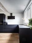 black flat screen tv mounted on white wall