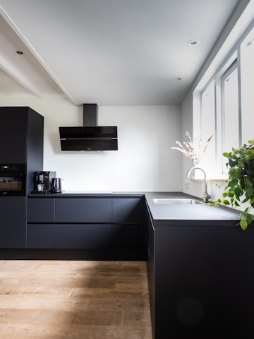 Elegant modern kitchen hardware installation showcasing sleek black and metallic finishes.