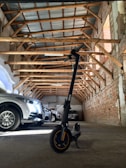Scooter parked inside the garage with visible toolboxes and equipment around, highlighting the professional setting.