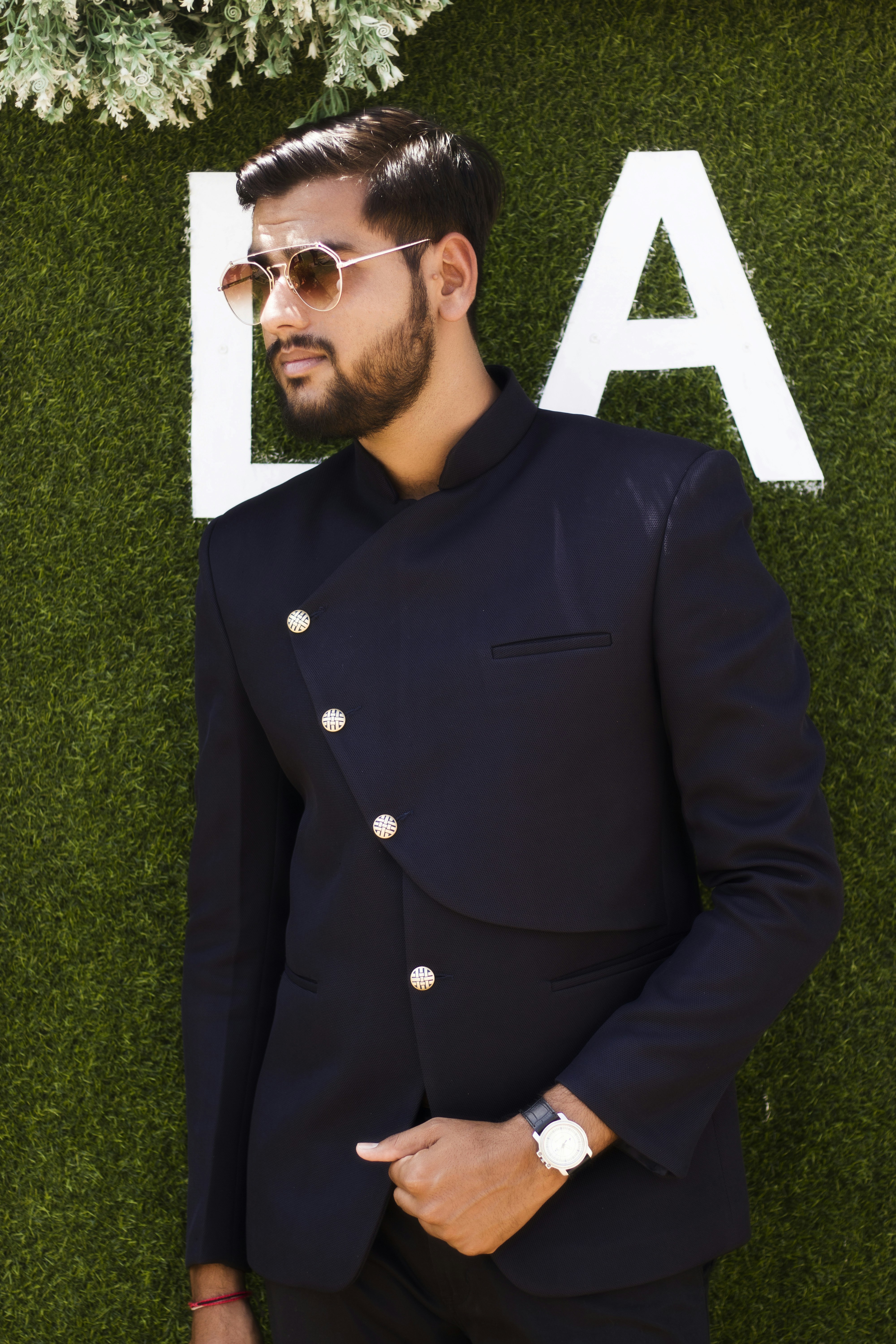 man in black suit jacket wearing black sunglasses